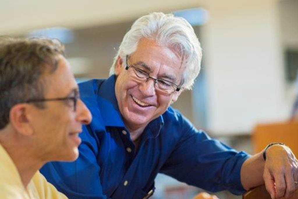 Job Search Coaching for Unemployed Workers A men helping another men on a computer