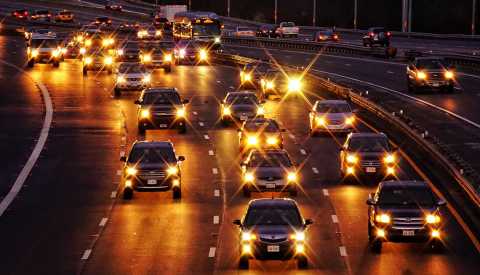 headlights on a highway in arlington in the evening
