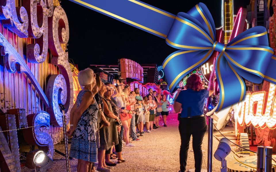 A picture of a tour in the Neon Boneyard with a blue ribbon over the image.