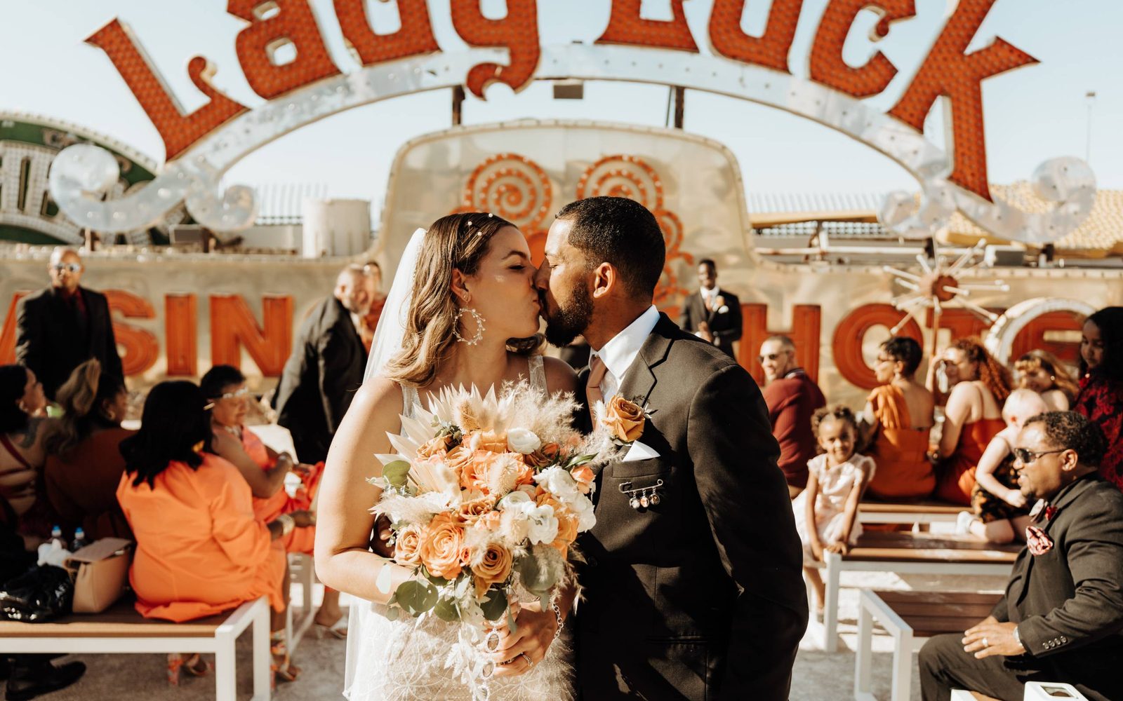 A couple kissing at their wedding at The Neon Museum's North Galleries.