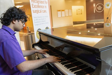 After a few months of volunteering at Dignity Health-St. Rose Dominican, Siena Campus, the baby grand piano in the hospital lobby caught Sachin Reddy's attention. He approached the volunteer services manager and asked if he could play it.