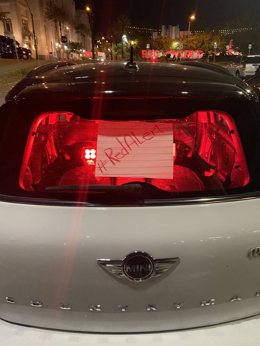 A Mini Cooper with its interior lit up in red is shown in the Smith Center parking lot during t ...