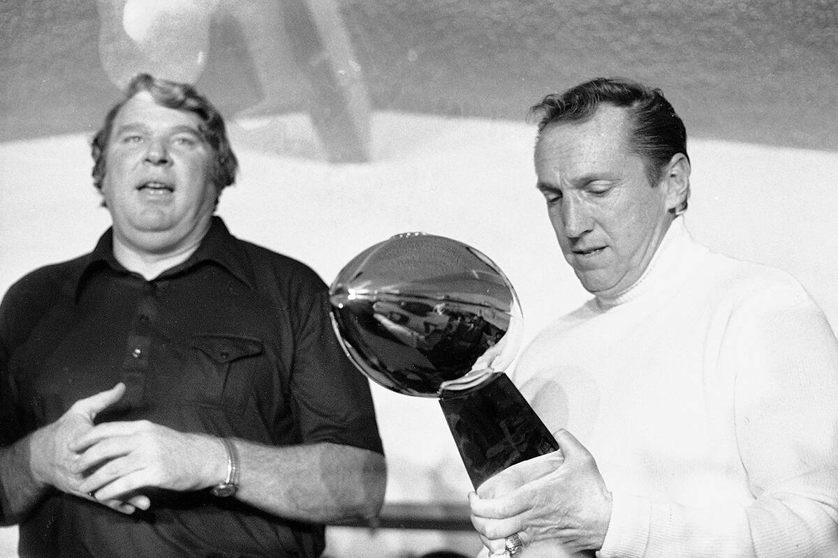 Oakland Raiders coach John Madden, left, and team owner Al Davis, holding the NFL football Supe ...