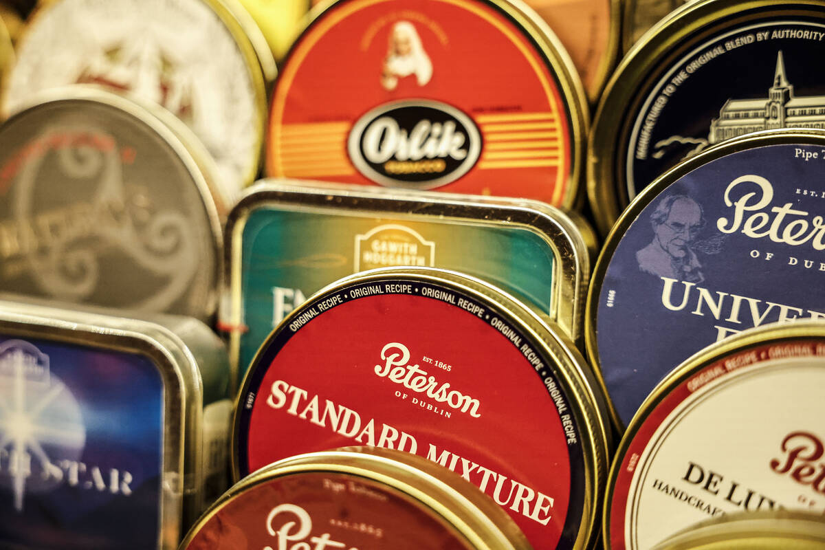 Various tobacco tins are photographed lining the walls at The Dark Arts room at Grey Witch Tues ...