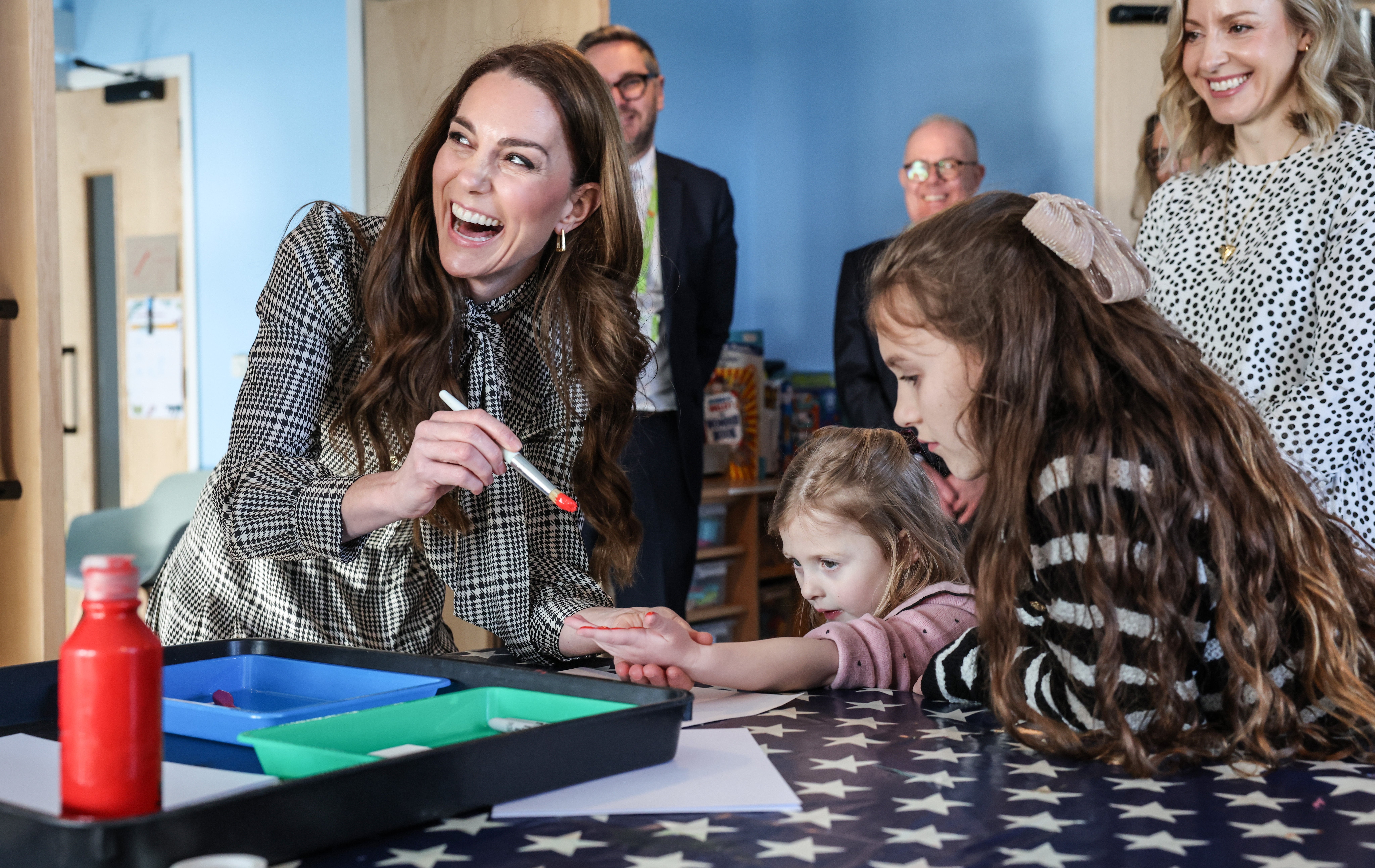 The Princess of Wales paints the hand of four-year-old Maggie during a visit to the Ty Hafan hospice in Sully, near Cardiff, South Wales (Richard Pohle/The Times/PA)
