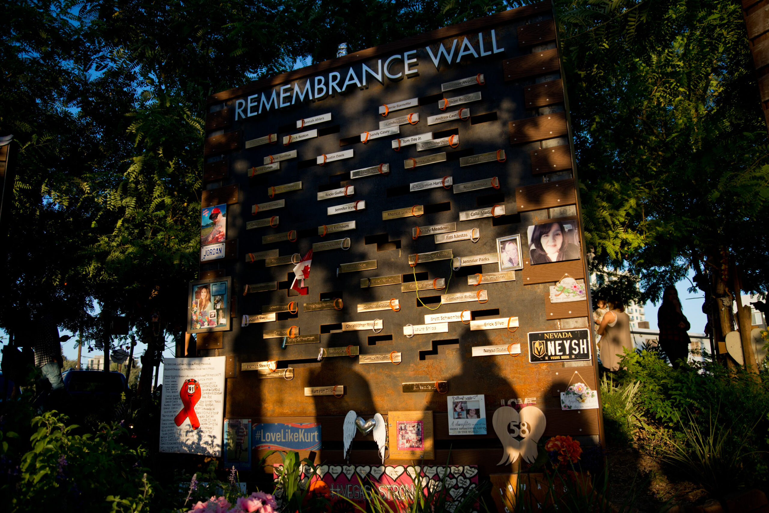 People pay respects to the victims of the Route 91 Harvest Festival shooting at the Las Vegas Community Healing Garden in Downtown Las Vegas.