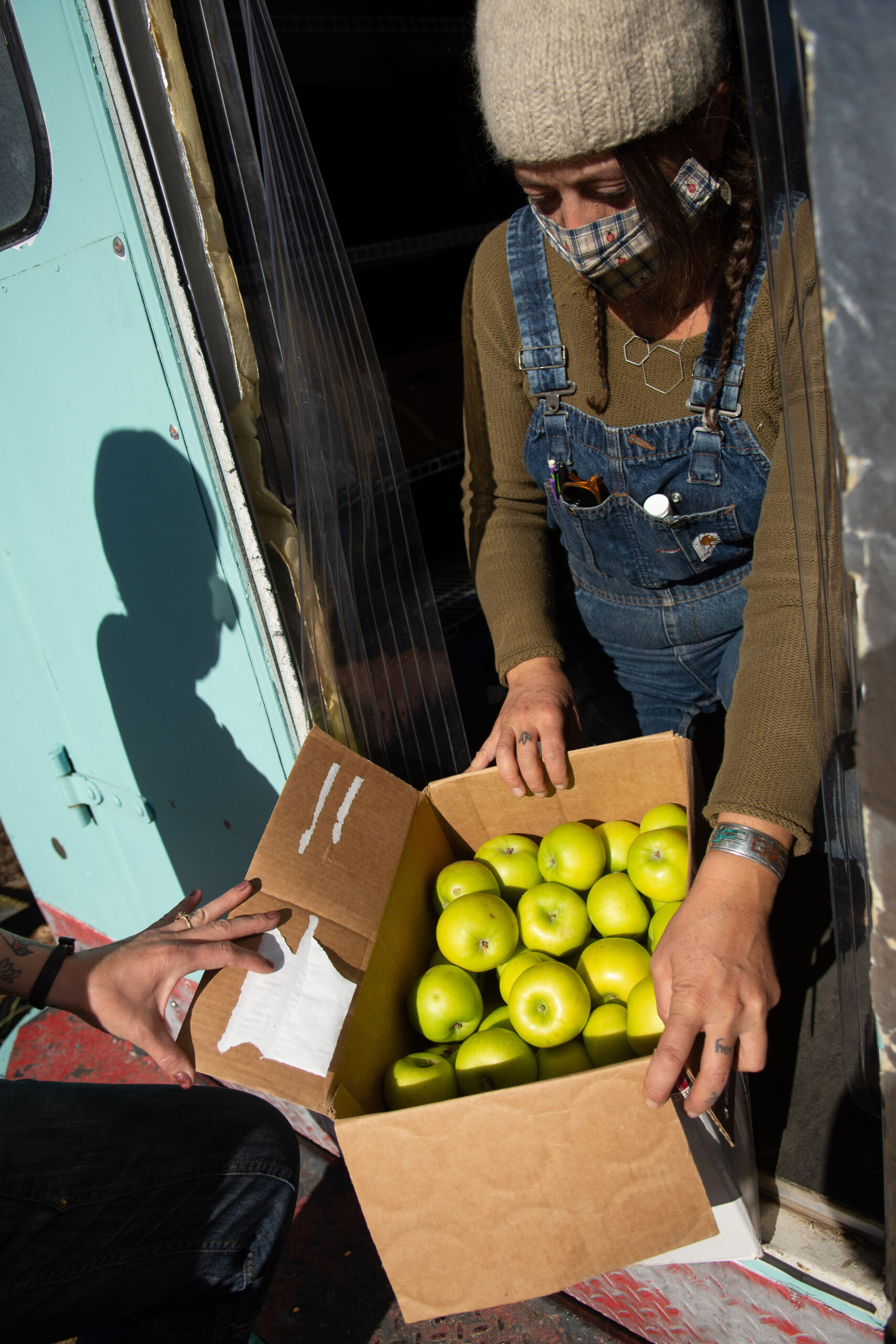 Lyndsey Langsdale with a box of gleaned apples donated to Reno Food Systems from an orchard in Ely on Nov. 22, 2020.