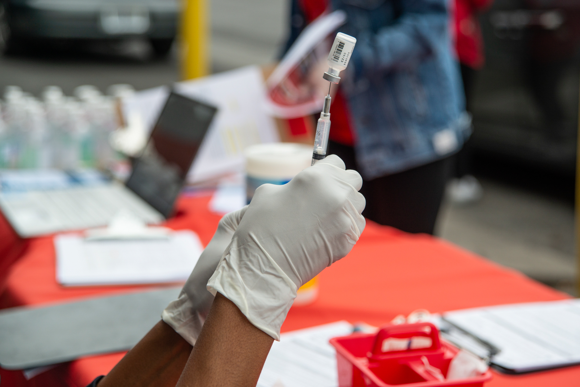 Volunteers with Roseman University prepare to administer vaccines at the Asian Community Development Council food pantry.