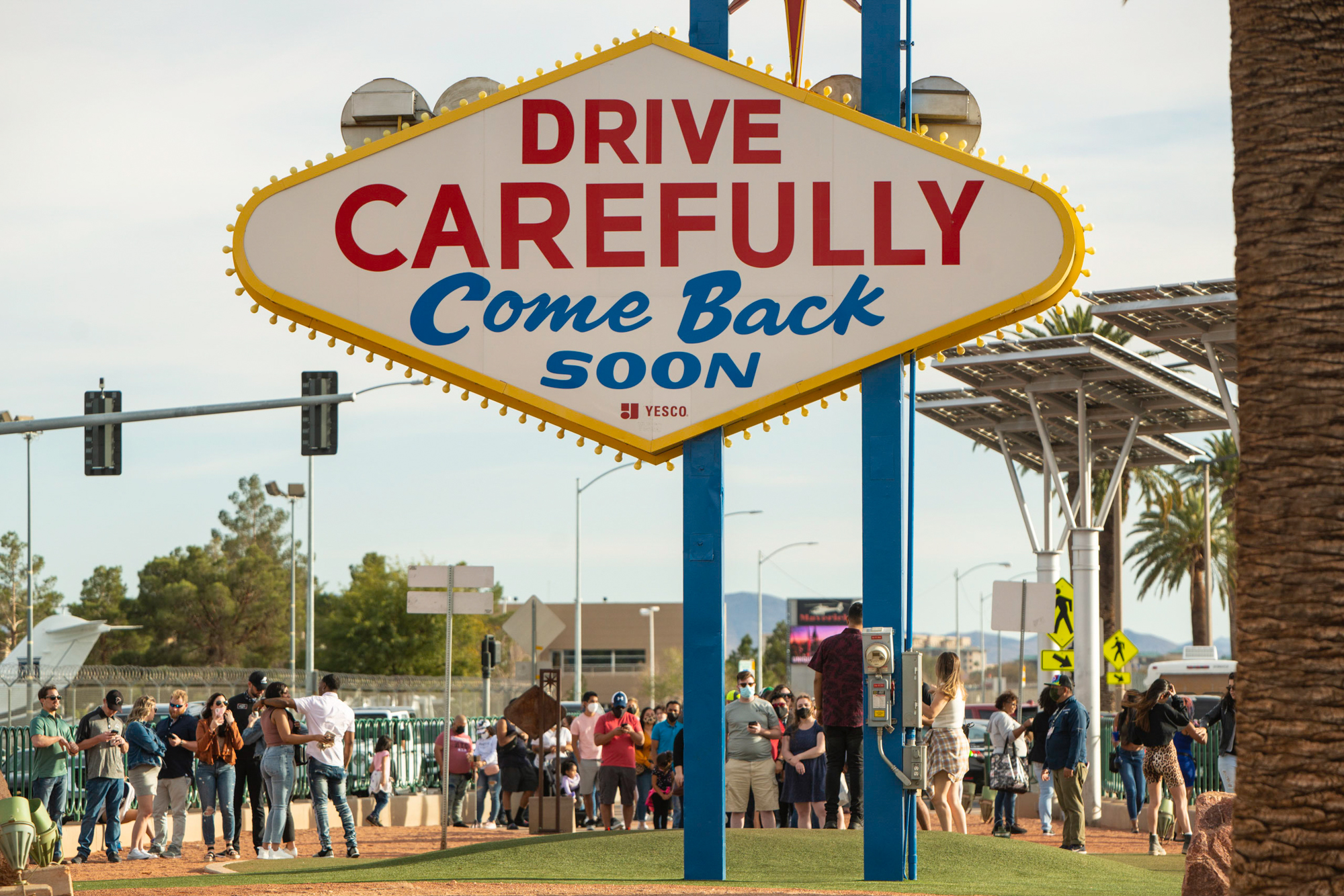 People wait to take their pictures in front of the Las Vegas sign on the Las Vegas Strip.
