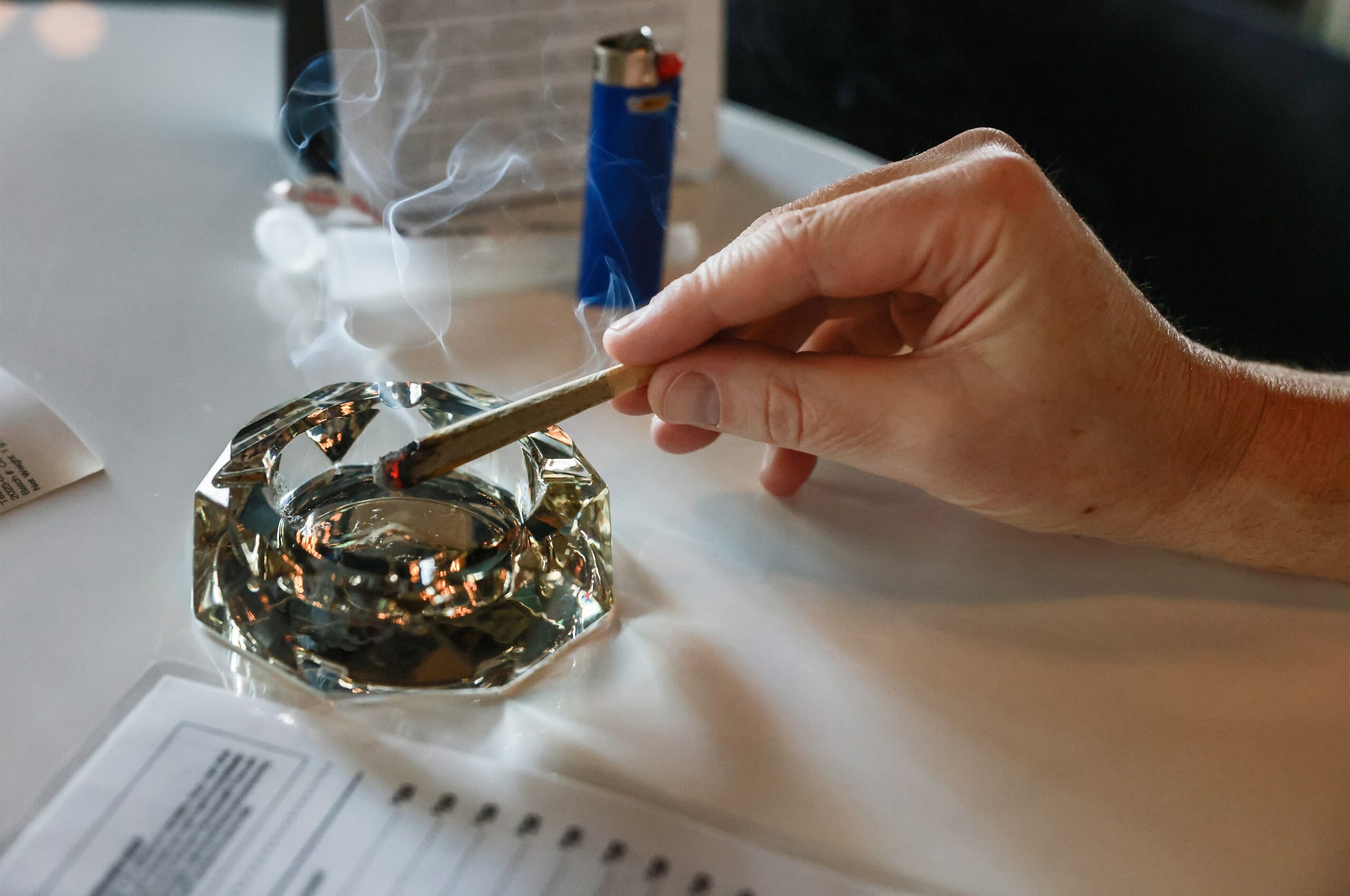 A tourist at Smoke and Mirrors cannabis lounge samples a marijuana preroll.