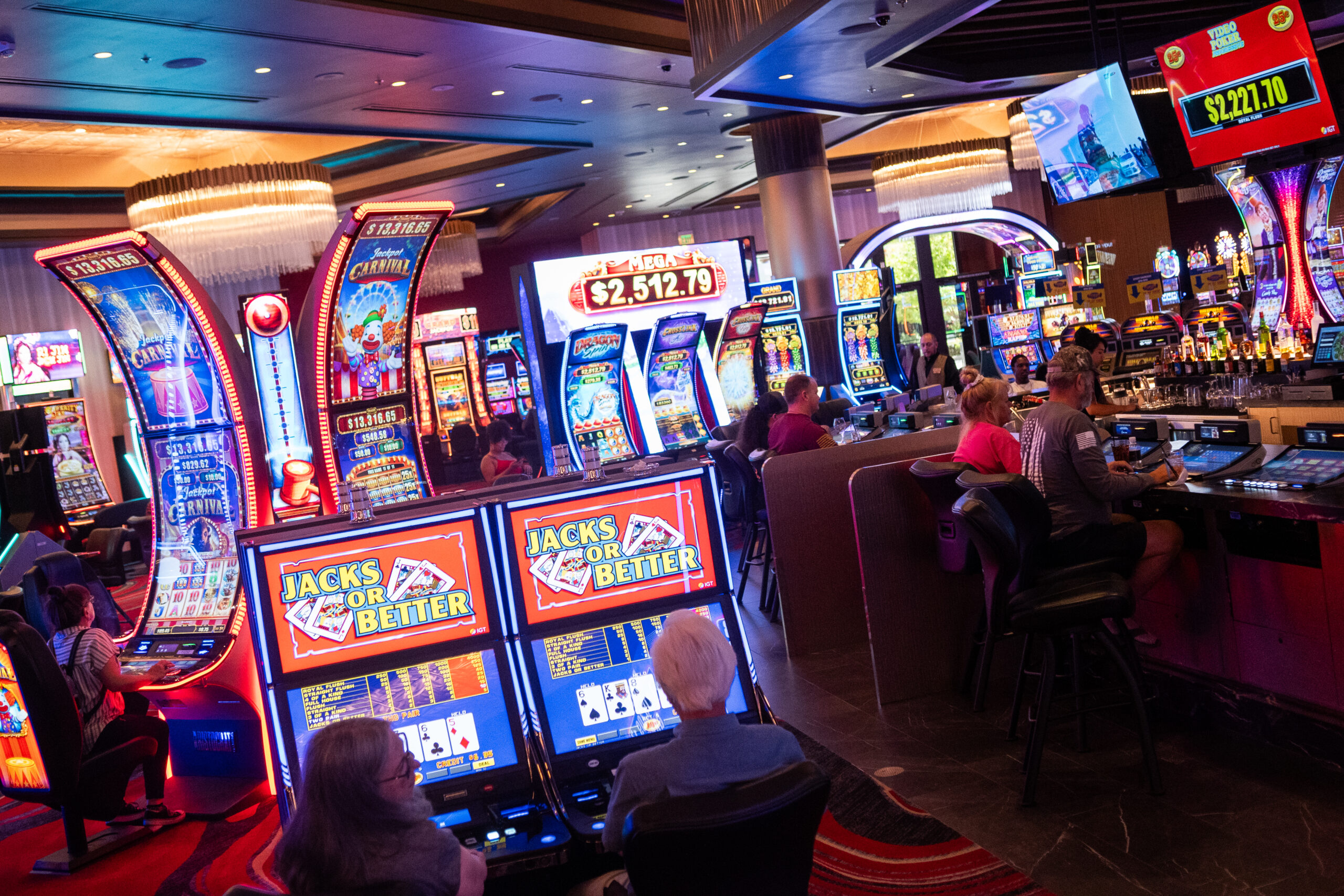 Slot machine players are seen at Legends Bay Casino in Sparks on Sept. 13, 2024.
