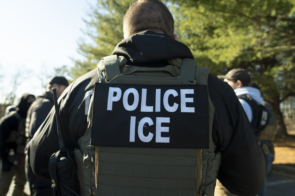 The back of U.S. Immigration and Customs Enforcement Baltimore Field Officer director Matt Elliston. His uniform reads "Police ICE."