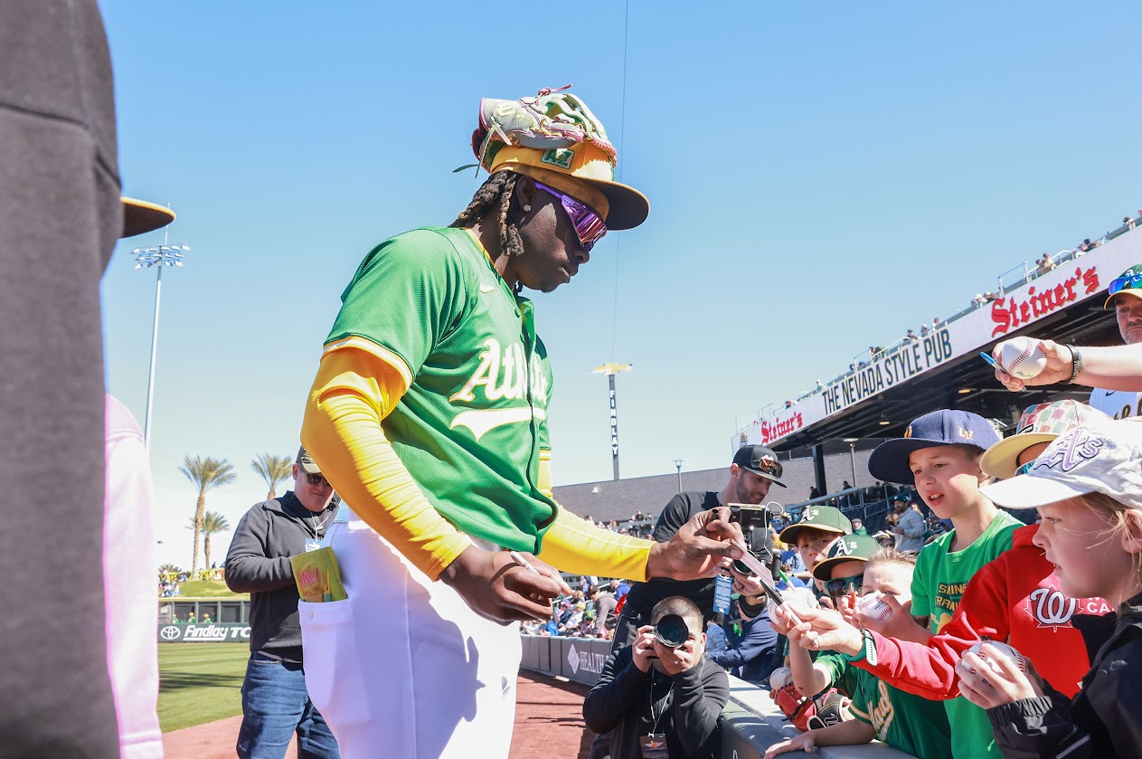 Athletics outfielder Lawrence Butler signs autographs before the start of the team's Big League Weekend game against the Arizona Diamondbacks at Las Vegas Ballpark on March 8, 2025. (Jeff Scheid/The Nevada Independent)