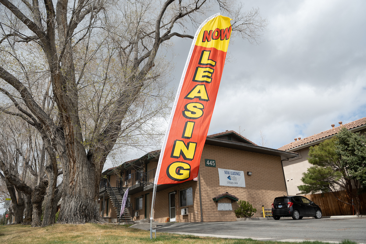 A house for rent that has a sign reading "Now Leasing."