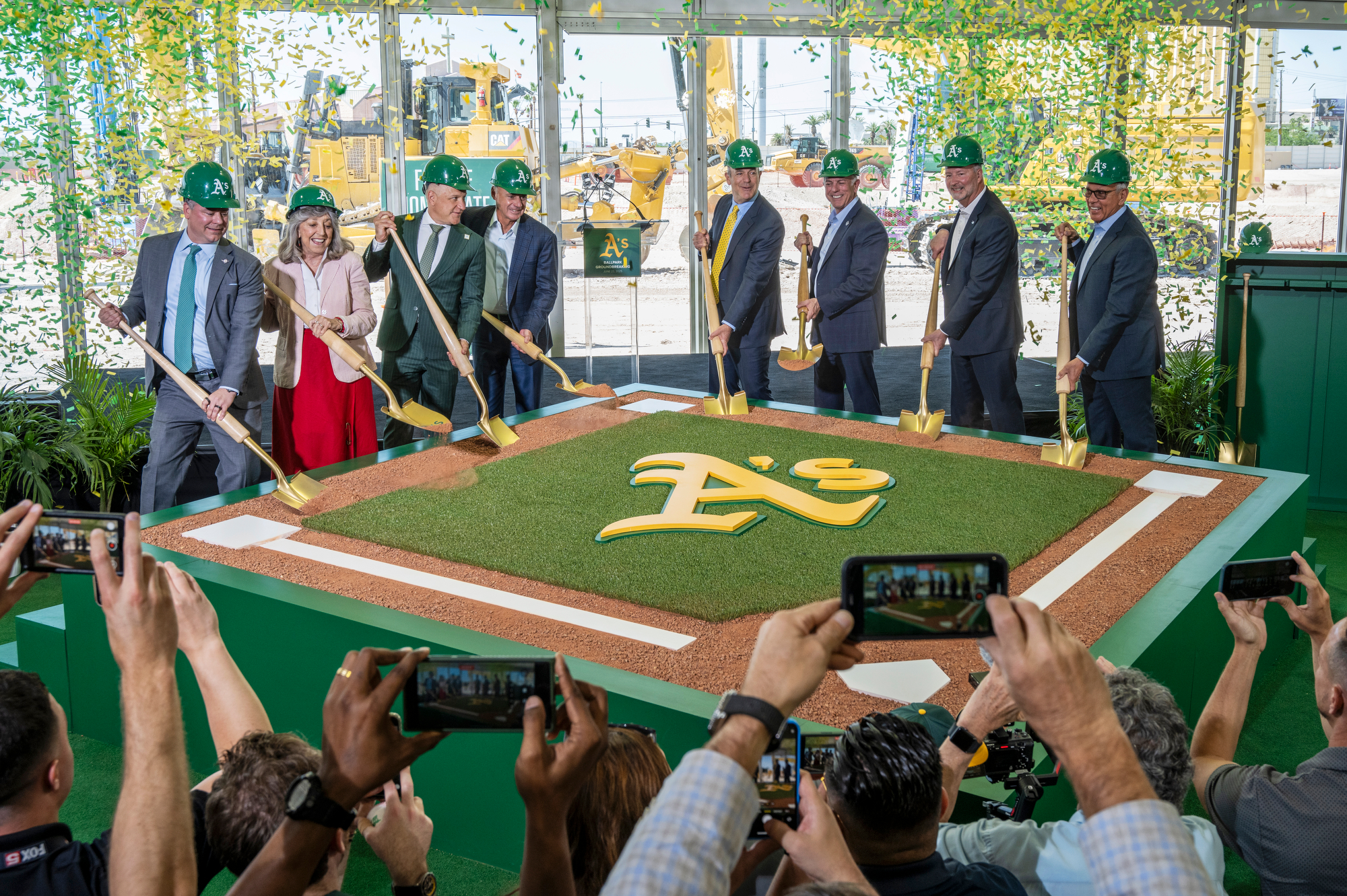 Athletics owner John Fisher, center-right, and Major League Baseball Commissioner Rob Manfred, center-left, are joined by invited dignitaries, including Gov. Joe Lombardo next to Fisher, for a ceremonial groundbreaking event at the site of the team's $1.75 billion Las Vegas baseball stadium.