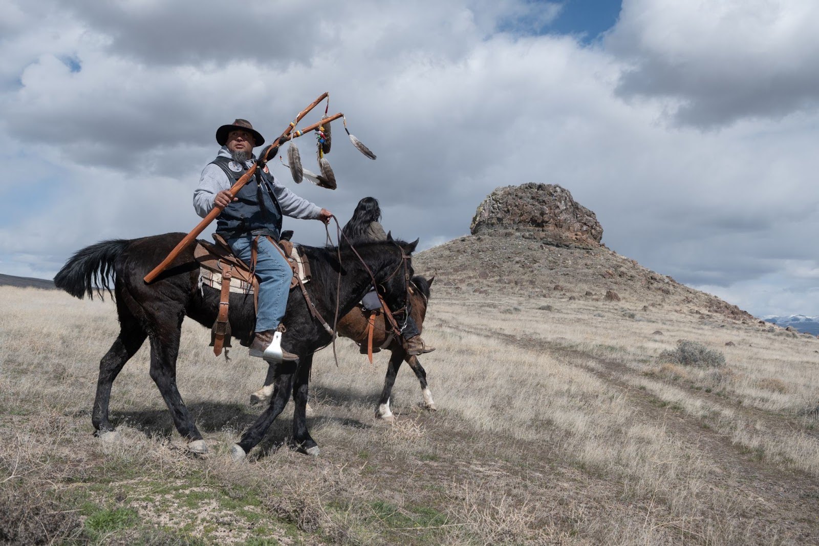 Prayer Horse Ride organizer Josh Dini, left, and Gary McKinney, a member of a group opposing the Thacker Pass lithium mine in Northern Nevada, pass Sentinel Rock.