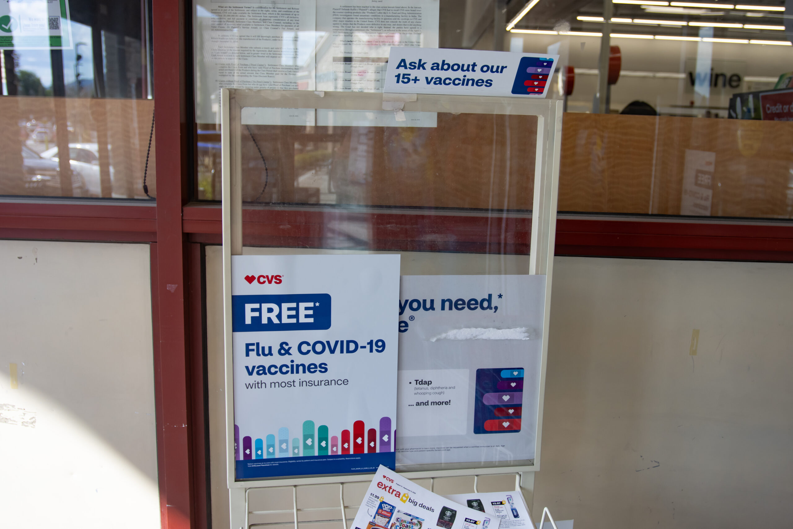 A sign in the entrance of a CVS Pharmacy promoting free flu and COVID-19 vaccines in Sparks.