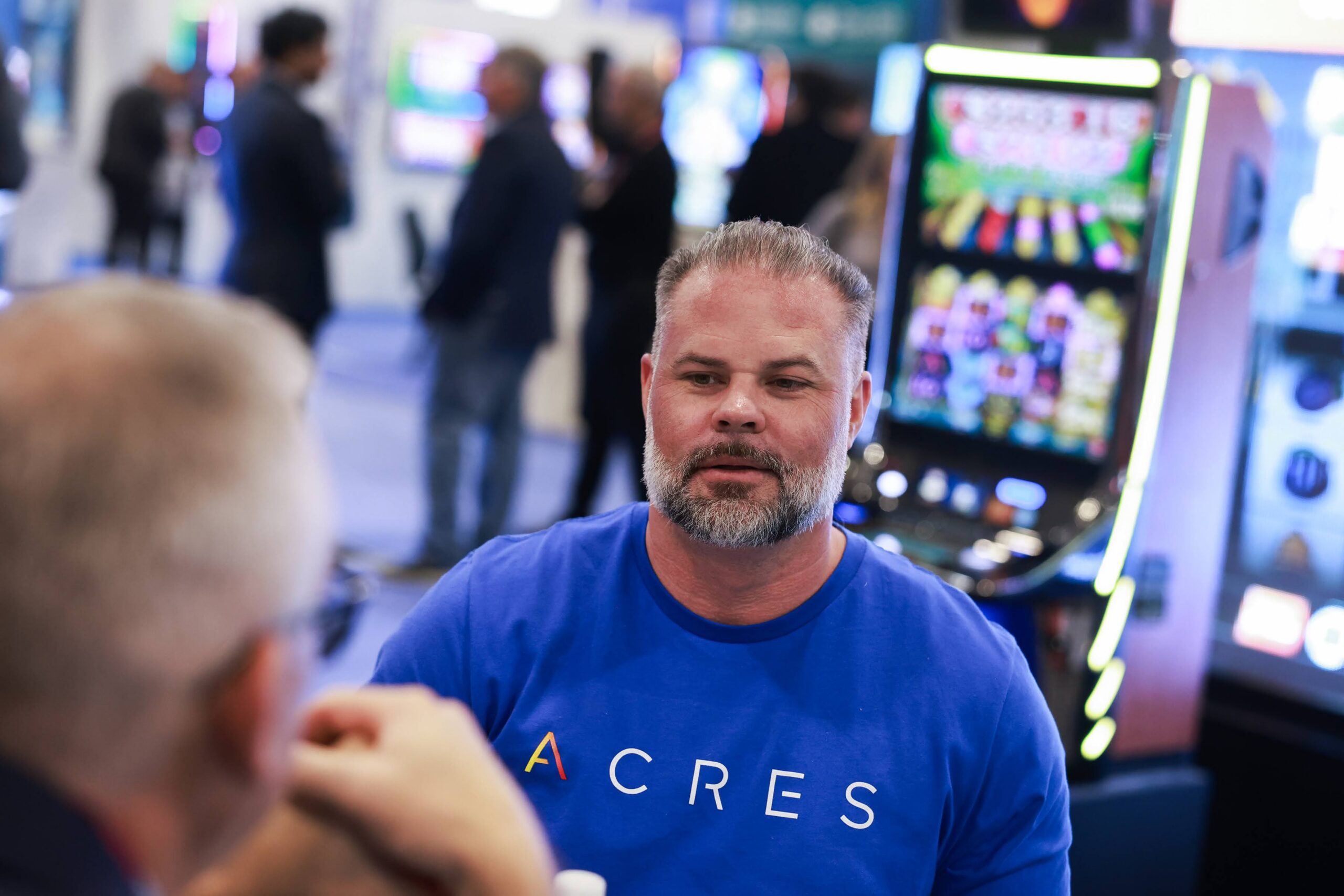 Acres Gaming executive Noah Acres visits with a customer during the Global Gaming Expo at The Venetian Expo.
