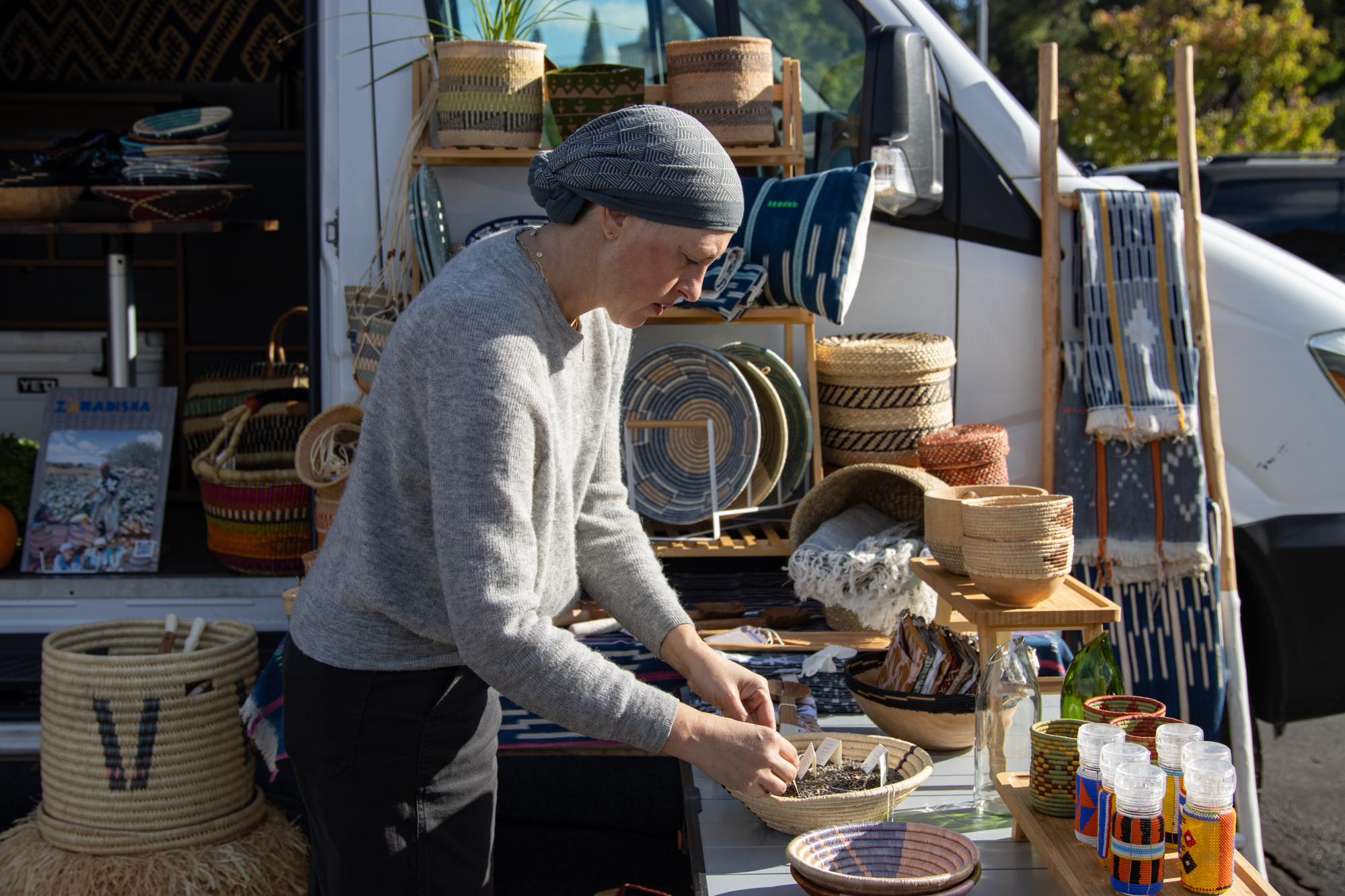 Jen Gurecki organizes items for her nonprofit Zawadisha at the Shirley Farmers Markets in Reno.