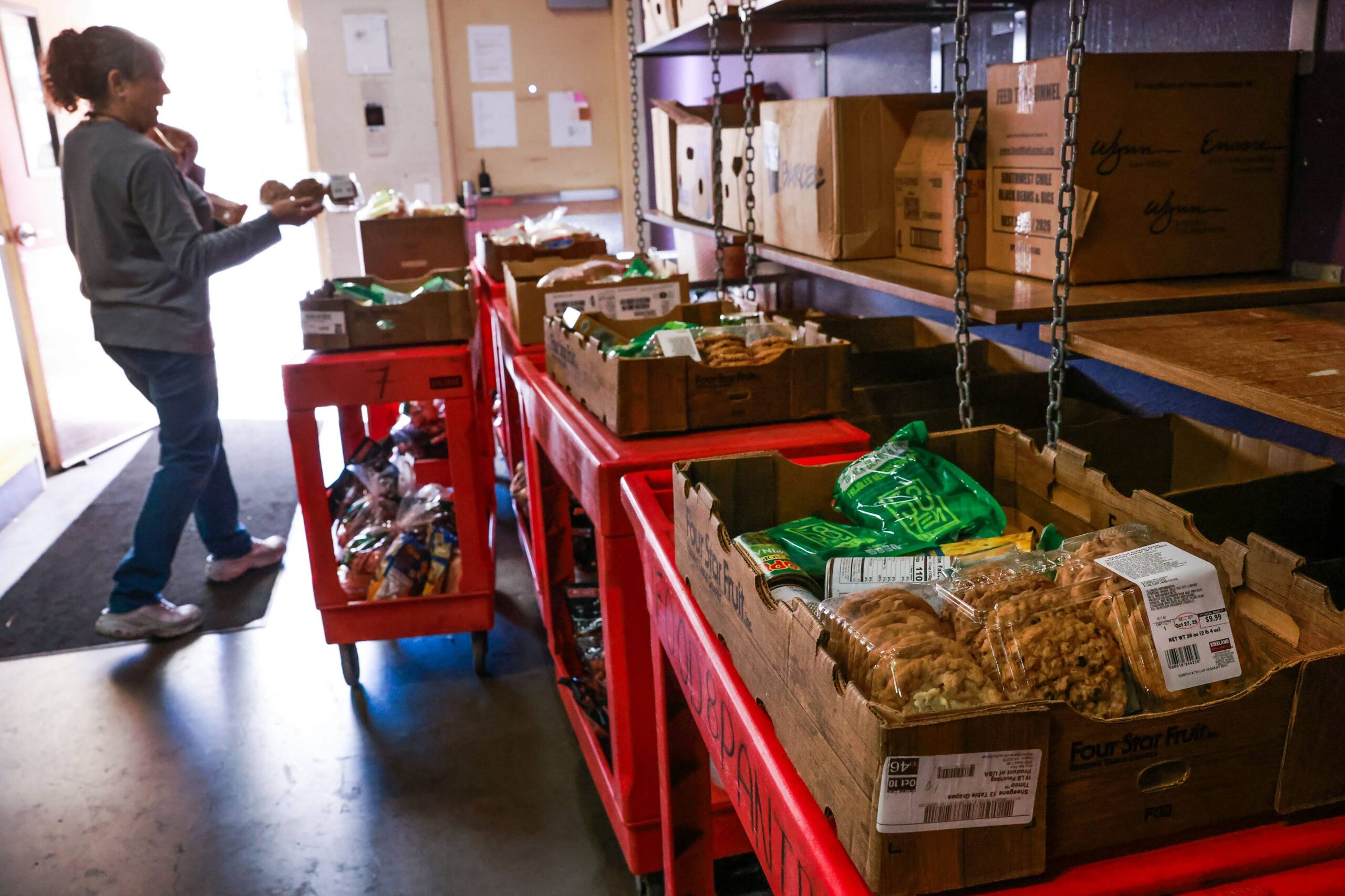 Personnel prepare boxes of food for clients at a food pantry run by Catholic Charities of Southern Nevada.