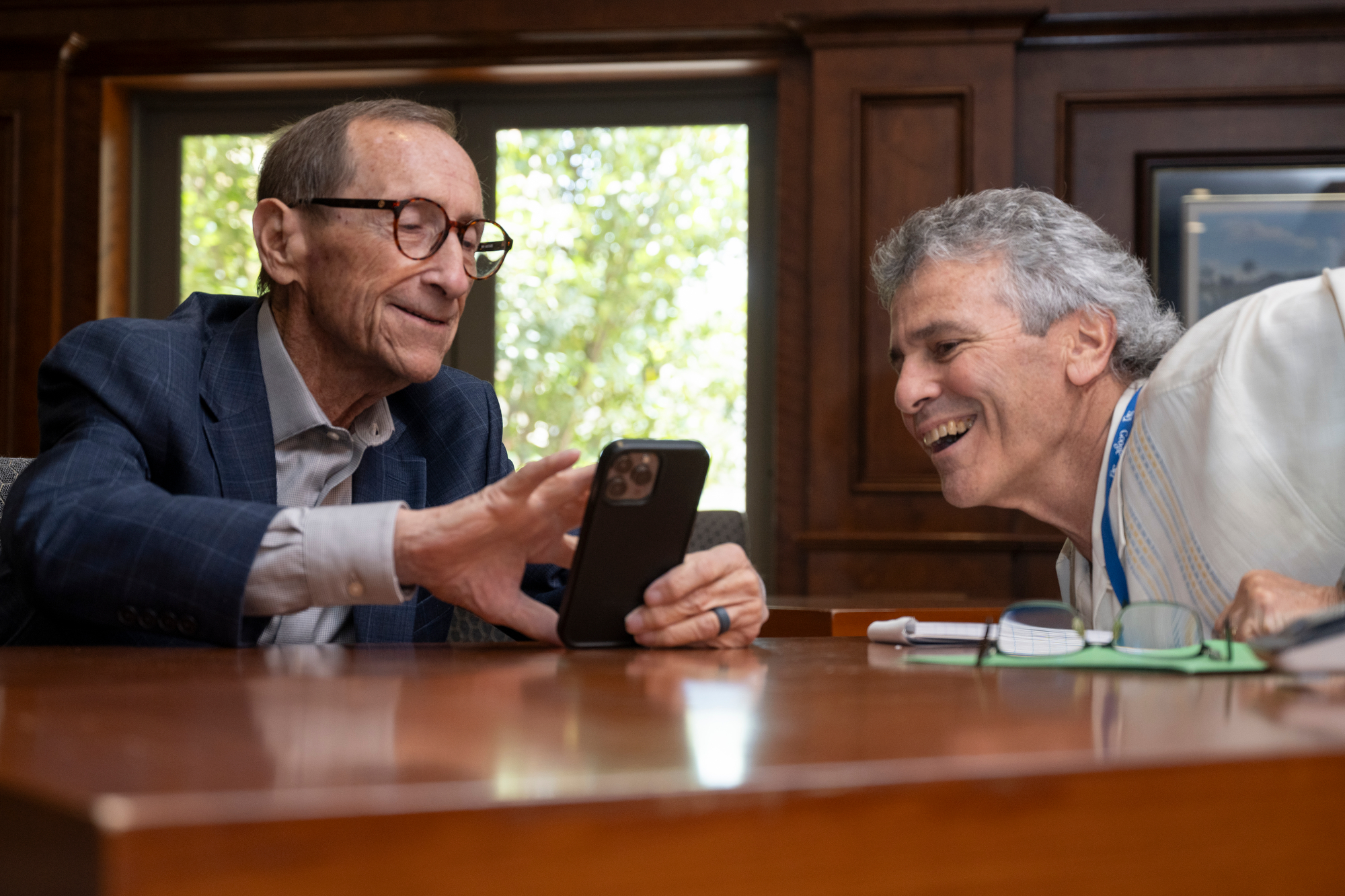 Rossi Ralenkotter, left, shows The Nevada Independent Senior Reporter Howard Stutz some photos of his grandchildren on his phone during an interview in the clubhouse at the Southern Highlands Golf Club.