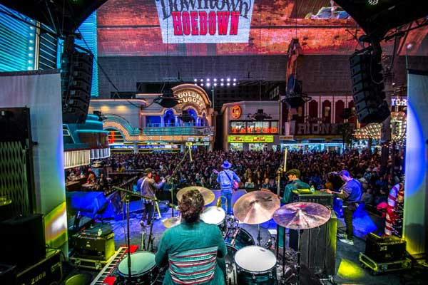 Everything You Need To Know About the Fremont Street Experience 4 A band playing on stage at the Fremont Street Experience.