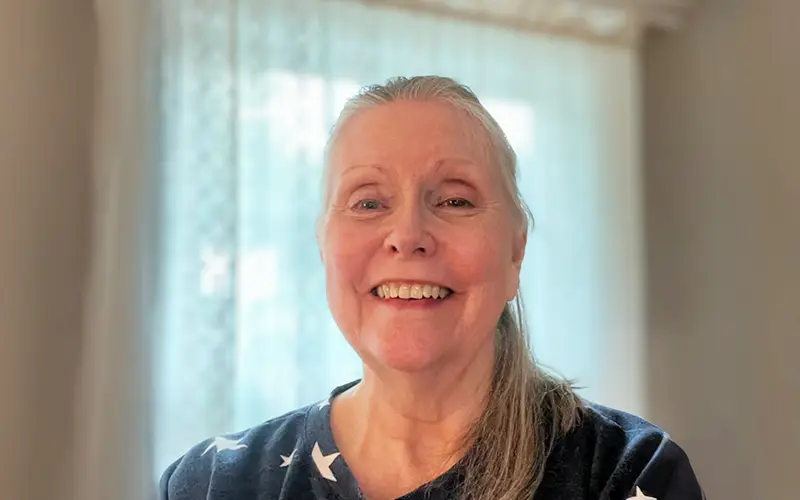 A woman smiles at the camera