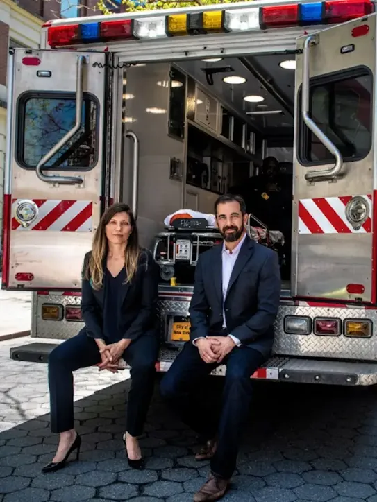 People sitting in the back of an ambulance