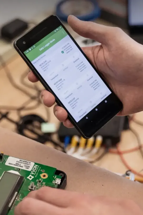 A hand holding a smartphone