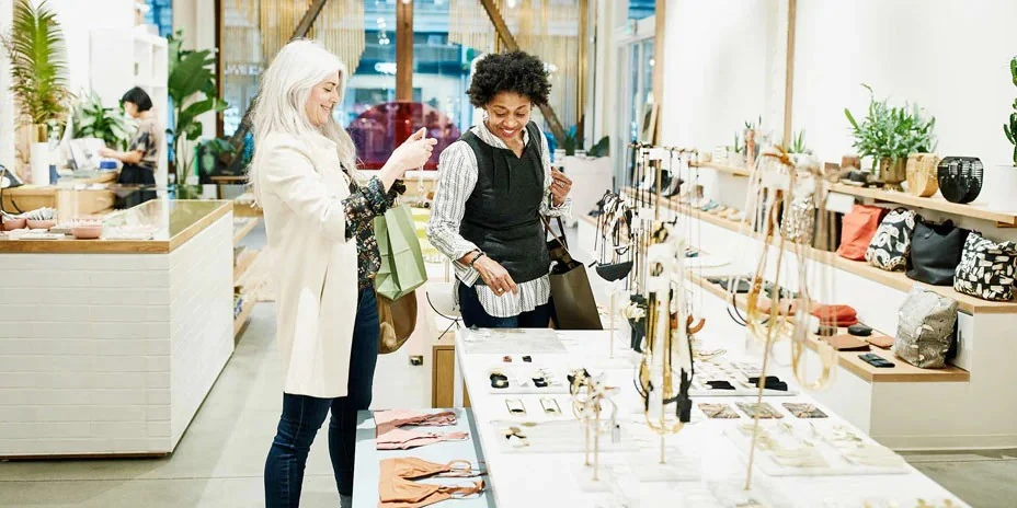 Two people looking at jewelry in a retail store