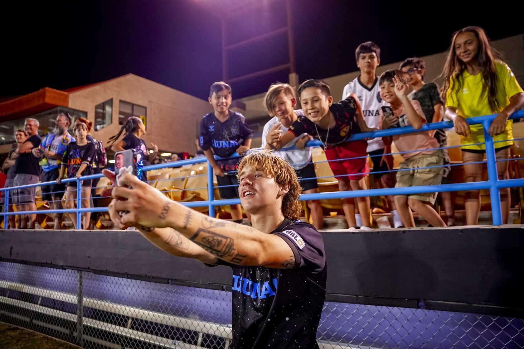 Image of Las Vegas Lights FC player taking selfie with fans