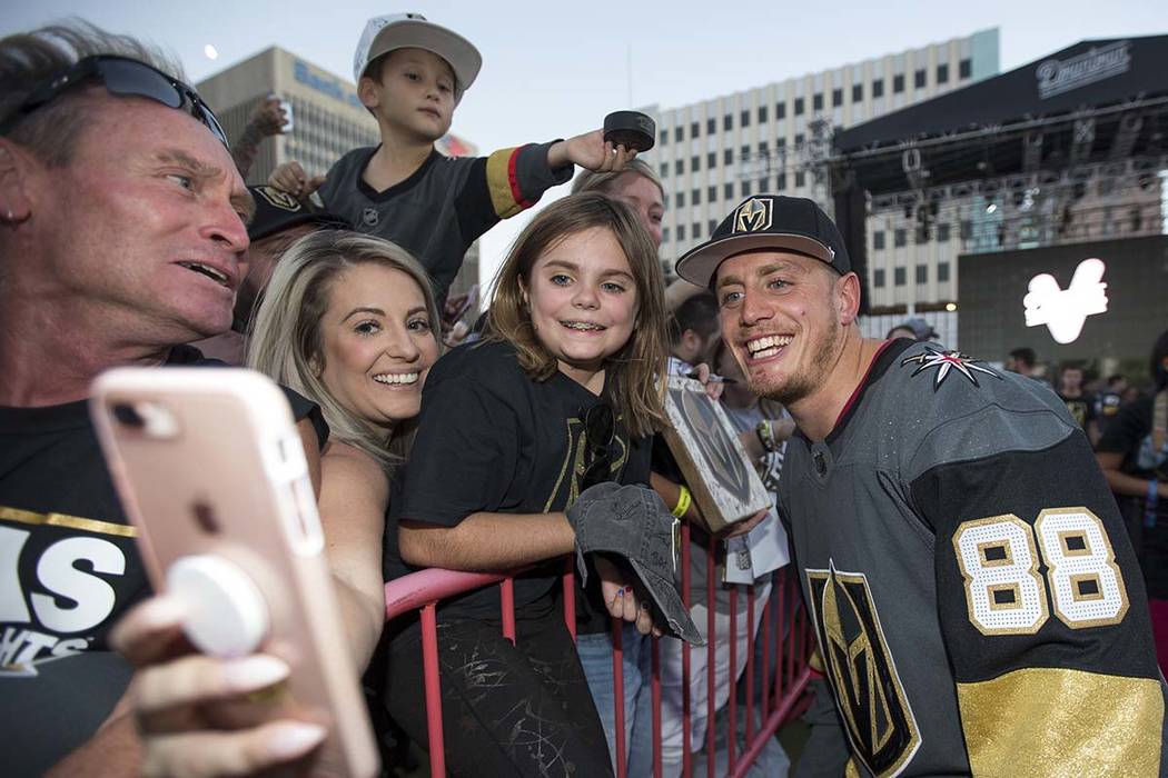Vegas Golden Knights defenseman Nate Schmidt (88) poses with fans during a Vegas Golden Knights ...
