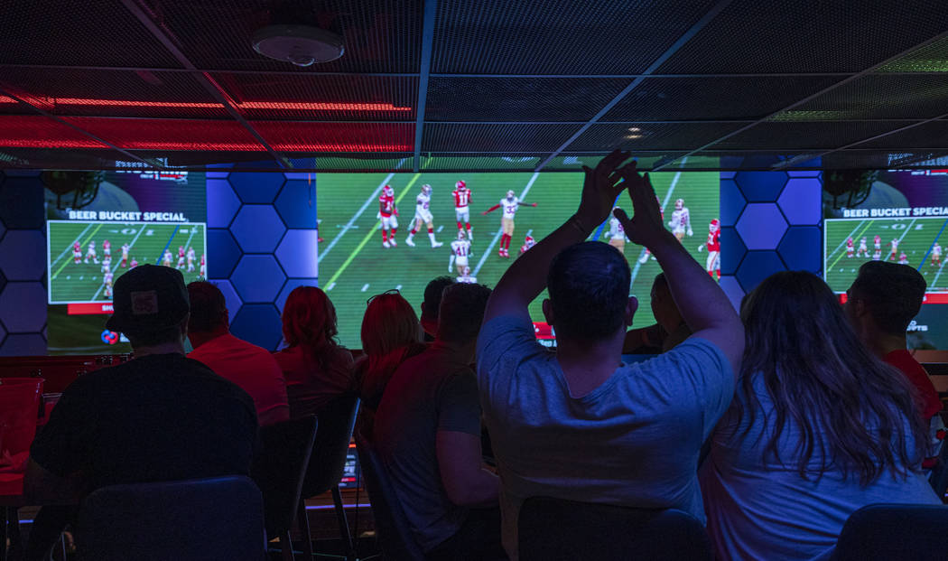 Individuals watch the NFL Super Bowl 54 football game between the San Francisco 49ers and Kansa ...