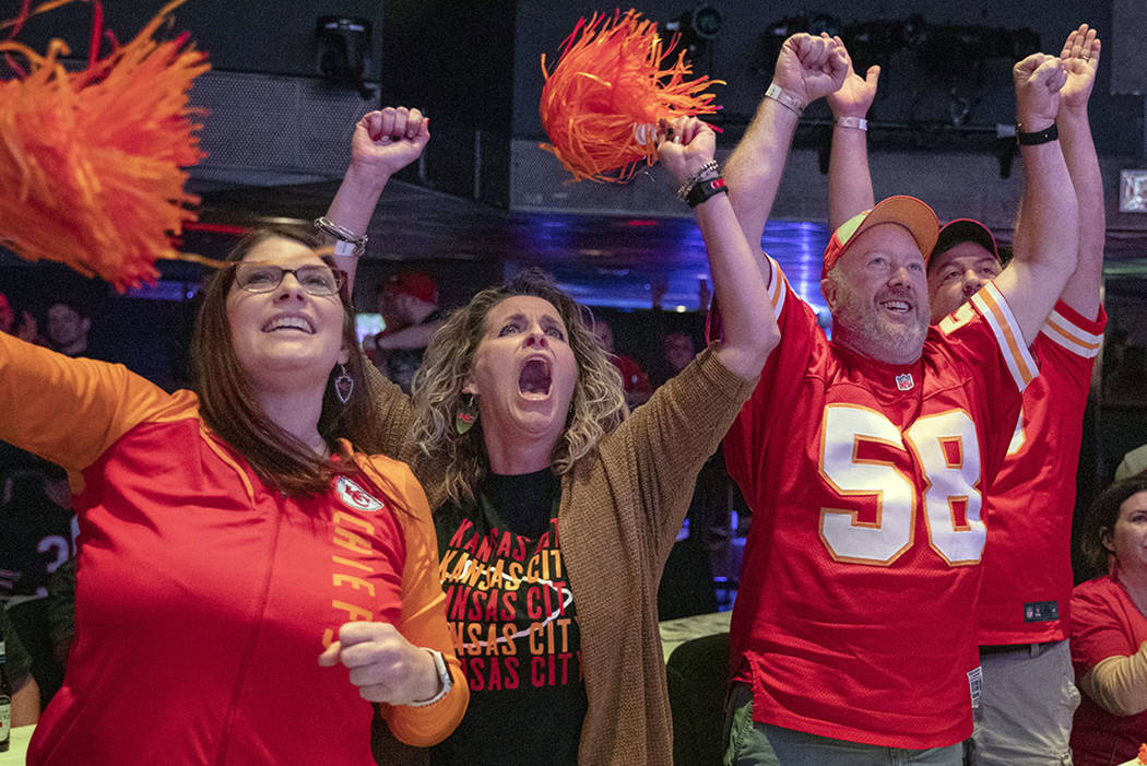 Kansas City Chiefs' fans Amy Teschner, left, Ashli Hanlan, center, and Mike Hanlen, of Kansas C ...