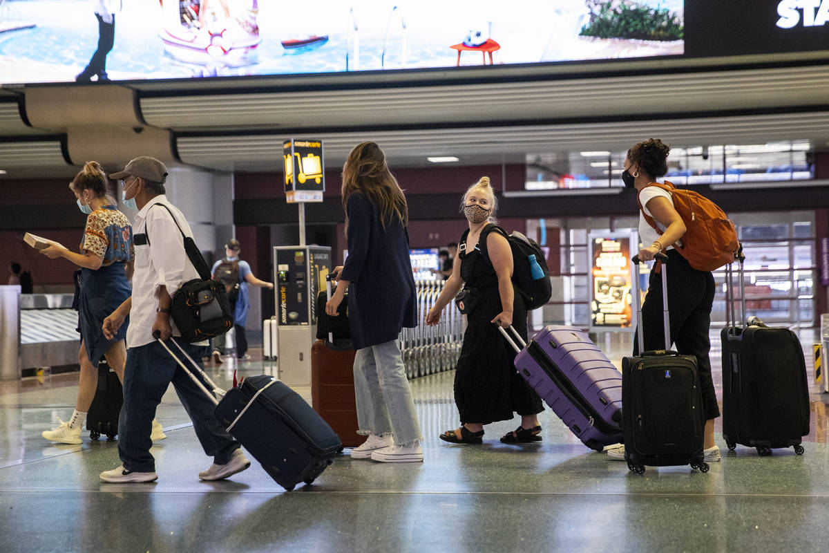 People arrive at McCarran International Airport Terminal 1 in Las Vegas, Friday, July 2, 2021. ...