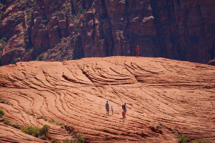 Visitors walk in the Petrified Dunes area of Snow Canyon State Park in Southern Utah on a late ...