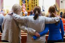 Community members hold each other as music plays during an October 7 attacks remembrance event ...