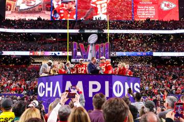 Kansas City Chiefs quarterback Patrick Mahomes (15) holds the Vince Lombardi Trophy after winni ...