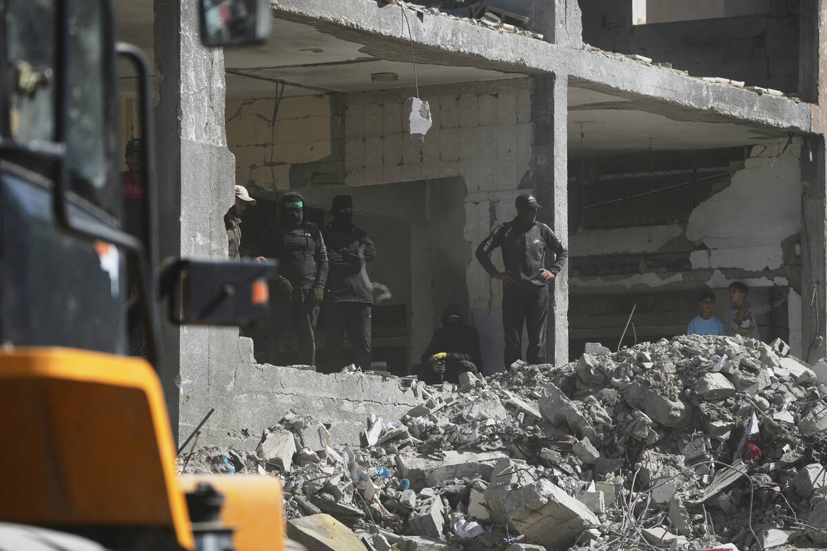 Members of the al-Qassam Brigades, the military wing of Hamas, along with Egyptian workers and ...