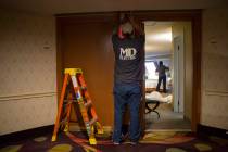Electrician Kris Kastnor replaces an old four foot florescent light with a LED strip light at L ...