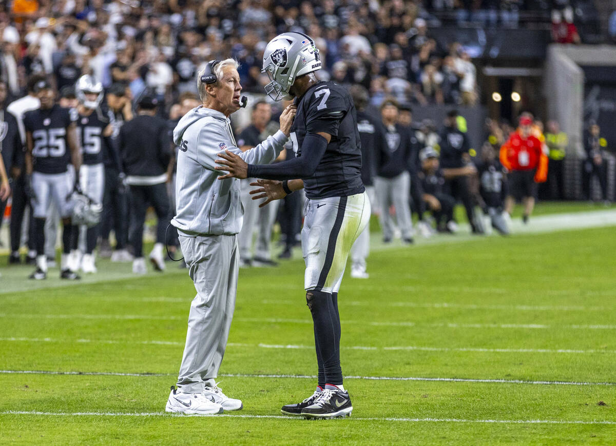 Raiders head coach Pete Carroll consoles quarterback Geno Smith (7) as they need a late score i ...