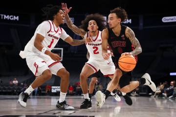 UNLV guard Dravyn Gibbs-Lawhorn (0) drives to the basket as Rutgers guards Jamichael Davis (1) ...
