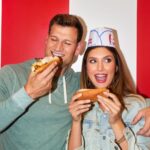 couple eating hot dogs